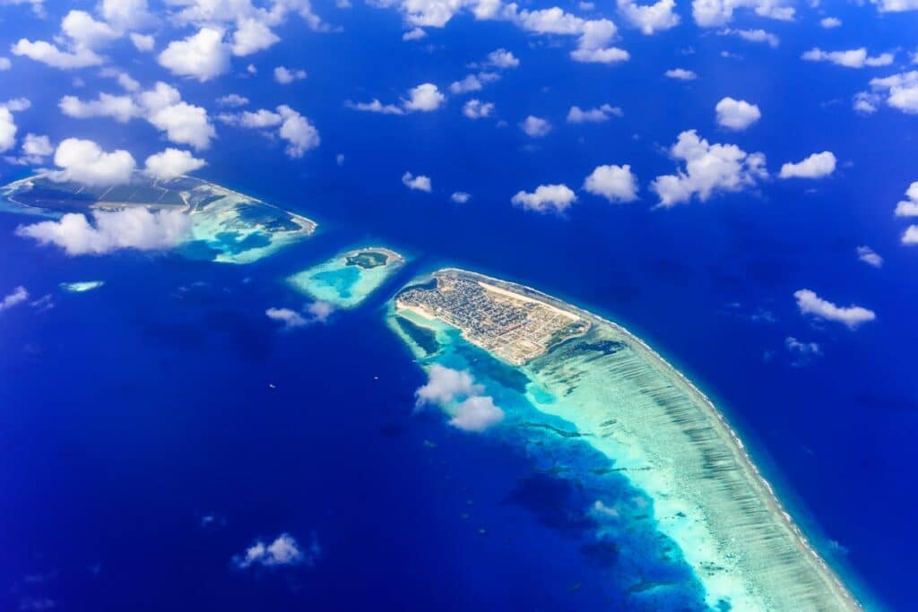 Aerial view of Maldives islands surrounded by turquoise waters.